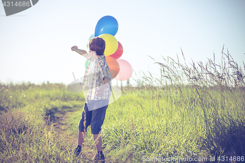 Image of Happy little boy playing on road at the day time.