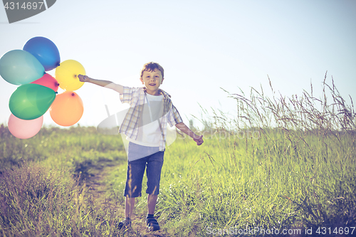 Image of Happy little boy playing on road at the day time.