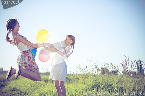 Image of Happy little children playing in the field at the day time.