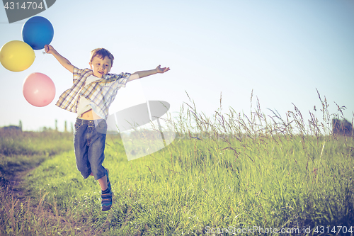 Image of Happy little boy playing on road at the day time.