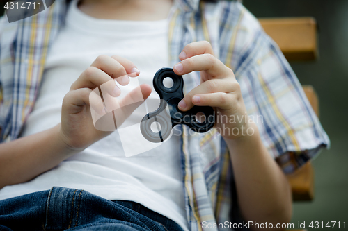 Image of Happy little boy playing in the park at the day time.