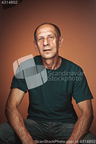 Image of Worried mature man sitting at studio