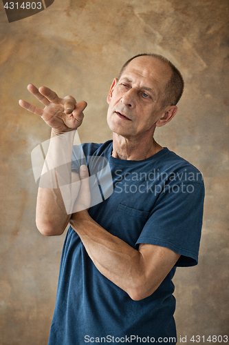 Image of Worried mature man standing at studio