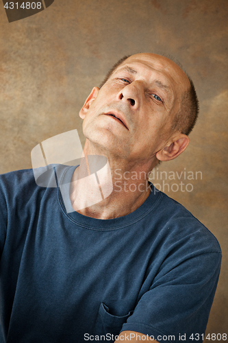 Image of Worried mature man sitting at studio