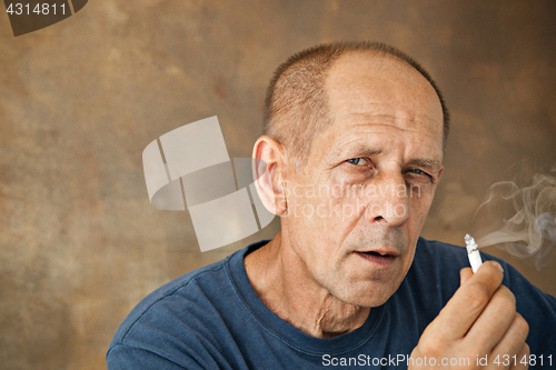 Image of Worried mature man sitting at studio