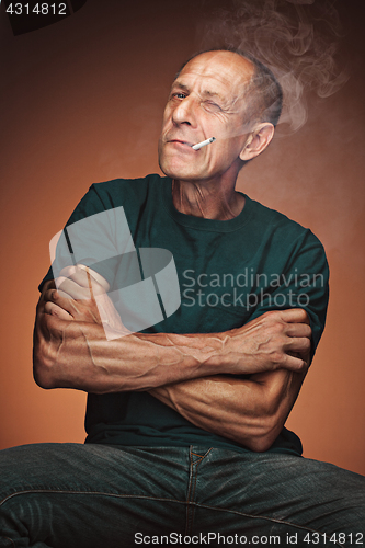 Image of Worried mature man sitting at studio