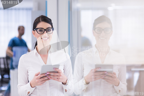 Image of Business Woman Using Digital Tablet in front of startup Office