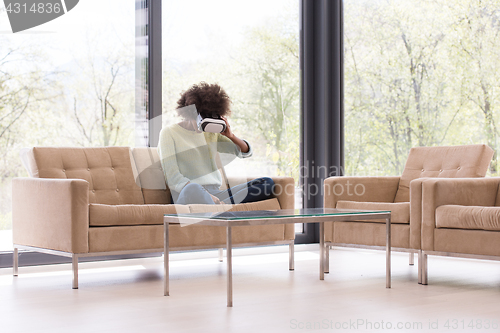 Image of black woman using VR headset glasses of virtual reality