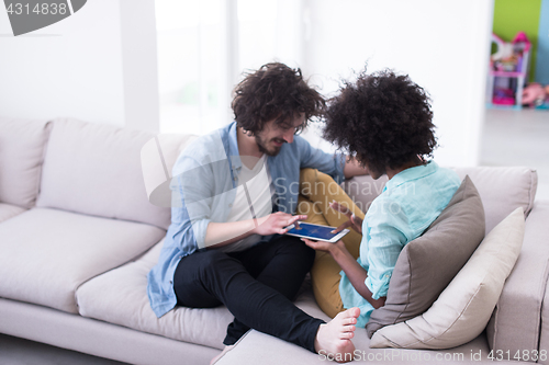 Image of multiethnic couple in living room