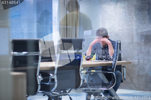 Image of young businessman relaxing at the desk