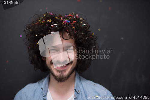 Image of man blowing confetti in the air