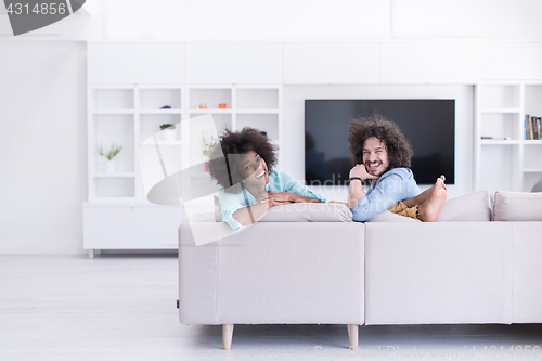 Image of young multiethnic couple in living room