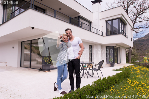 Image of couple hugging in front of  new luxury home