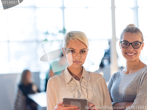 Image of Pretty Businesswomen Using Tablet In Office Building during conf