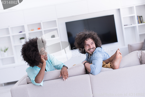 Image of young multiethnic couple in living room