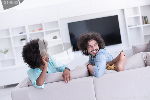 Image of young multiethnic couple in living room