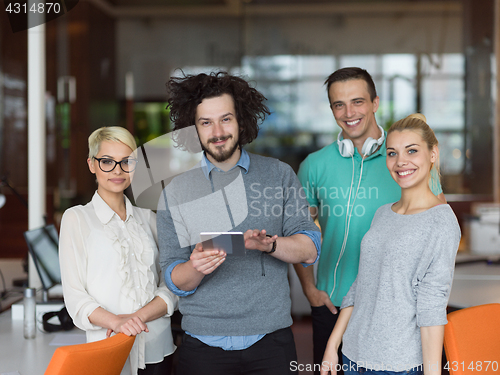 Image of group of Business People Working With Tablet in startup office