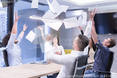 Image of startup Group of young business people throwing documents