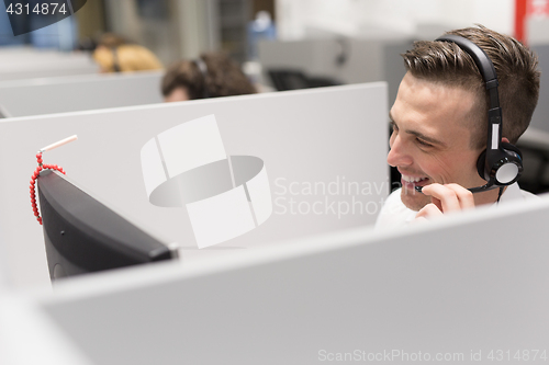 Image of male call centre operator doing his job
