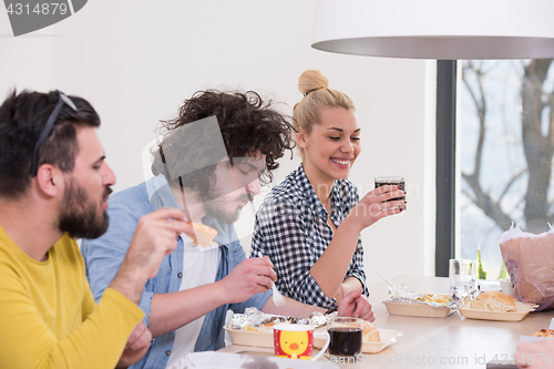 Image of multiethnic group of happy friends lunch time