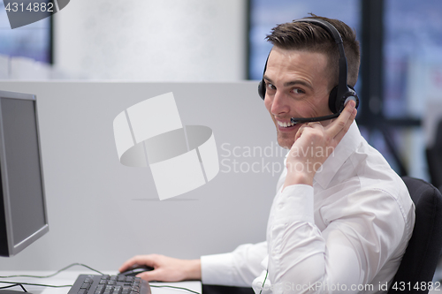 Image of male call centre operator doing his job