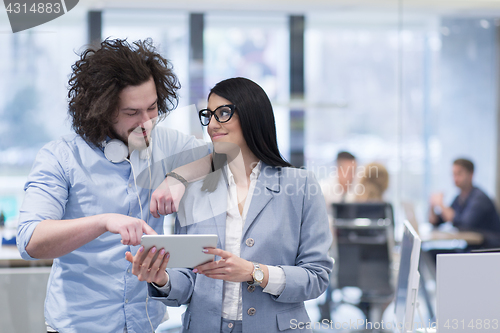 Image of Business People Working With Tablet in startup office