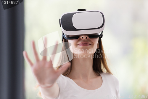 Image of woman using VR-headset glasses of virtual reality