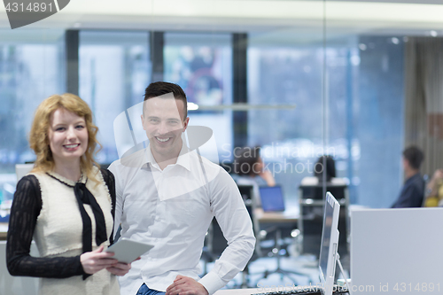 Image of Business People Working With Tablet in startup office