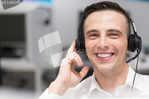 Image of male call centre operator doing his job