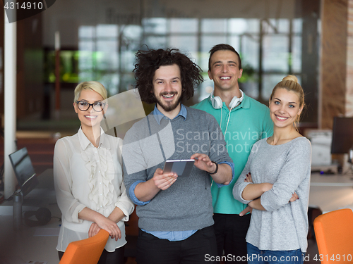 Image of group of Business People Working With Tablet in startup office