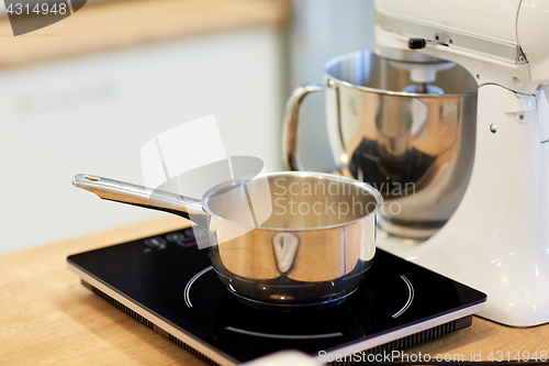 Image of electric mixer and pot on stove at kitchen