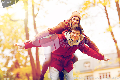 Image of happy young couple having fun in autumn park