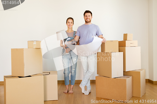 Image of couple with boxes and blueprint moving to new home