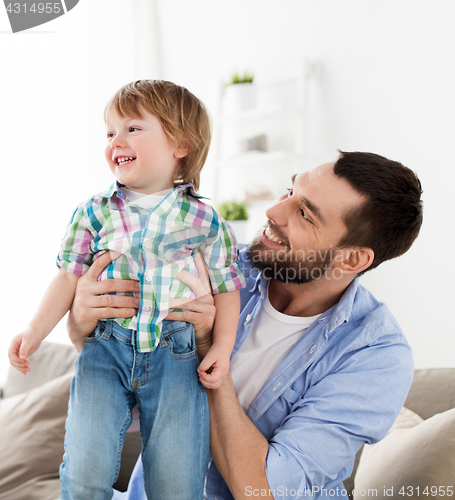 Image of happy father with little son at home