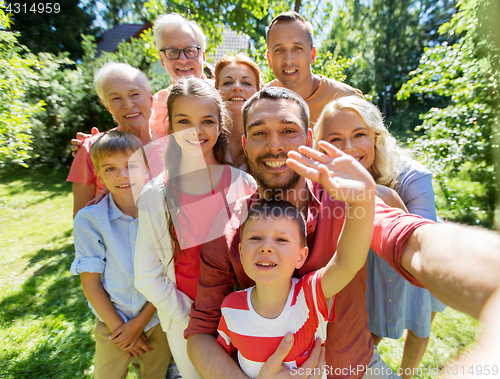 Image of happy family taking selfie in summer garden