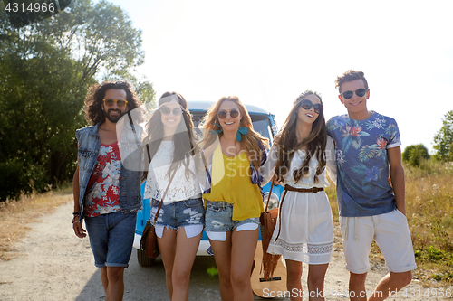 Image of smiling happy young hippie friends and minivan car
