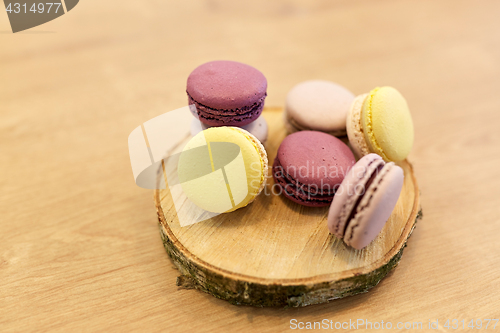 Image of different macarons on wooden stand