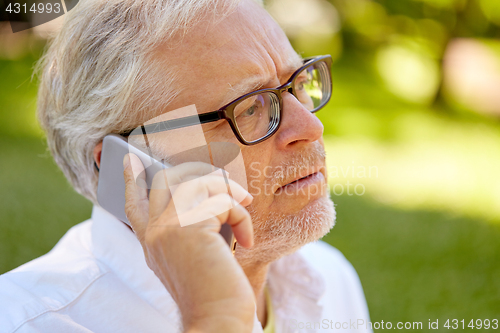 Image of senior man in glasses calling on smartphone