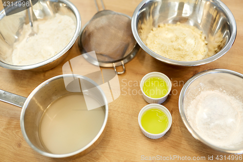 Image of bowls with flour and egg whites at bakery kitchen