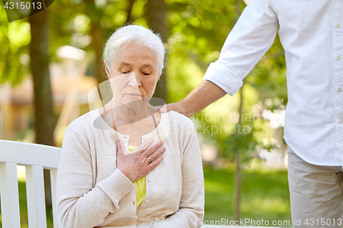 Image of senior woman feeling sick at summer park