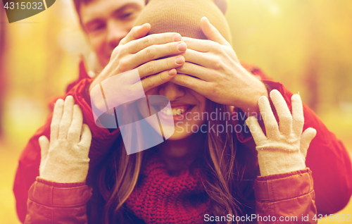 Image of happy young couple having fun in autumn park