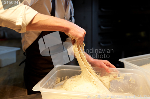 Image of chef or baker cooking dough at bakery