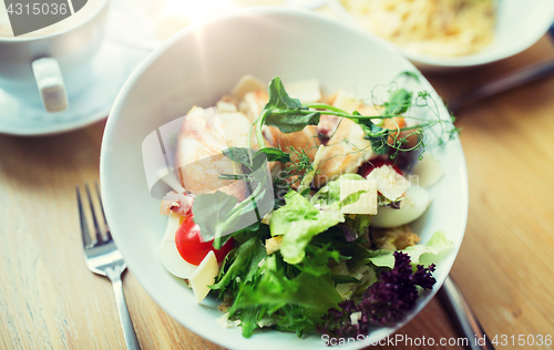 Image of close up of caesar salad on plate at restaurant