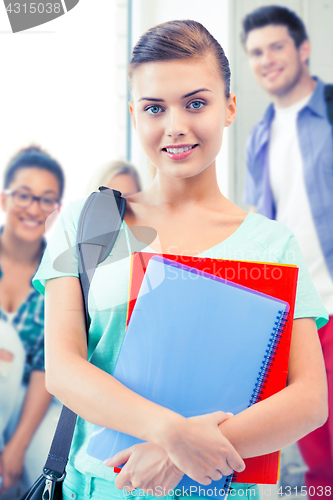 Image of student girl with school bag and notebooks