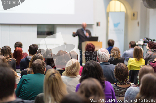 Image of Man giving presentation in lecture hall at university.