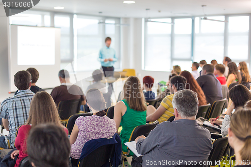 Image of Speaker giving presentation on business conference.