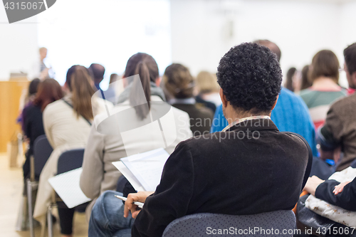 Image of Woman giving presentation on business conference.