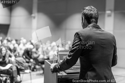 Image of Public speaker giving talk at Business Event.