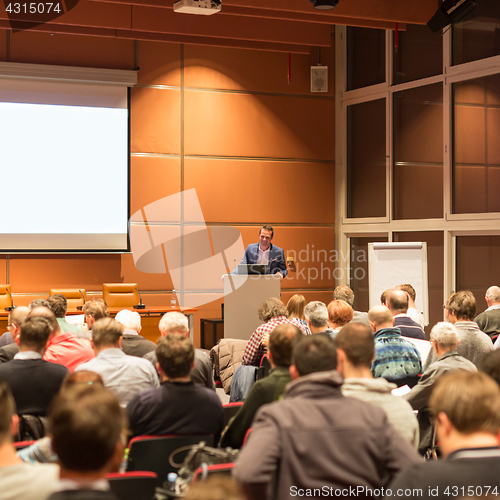 Image of Business speaker giving a talk at business conference event.