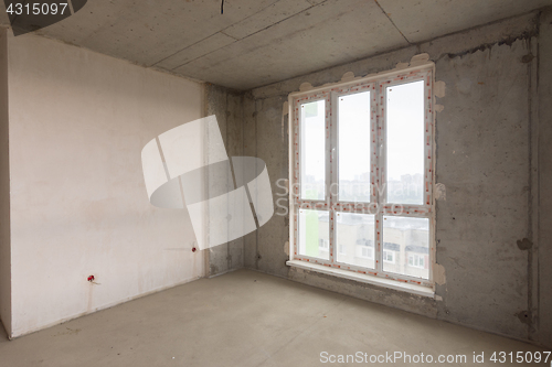 Image of Large stained glass window and plastered wall in a new building